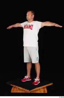 Louis dressed grey shorts red sneakers sports standing t poses…